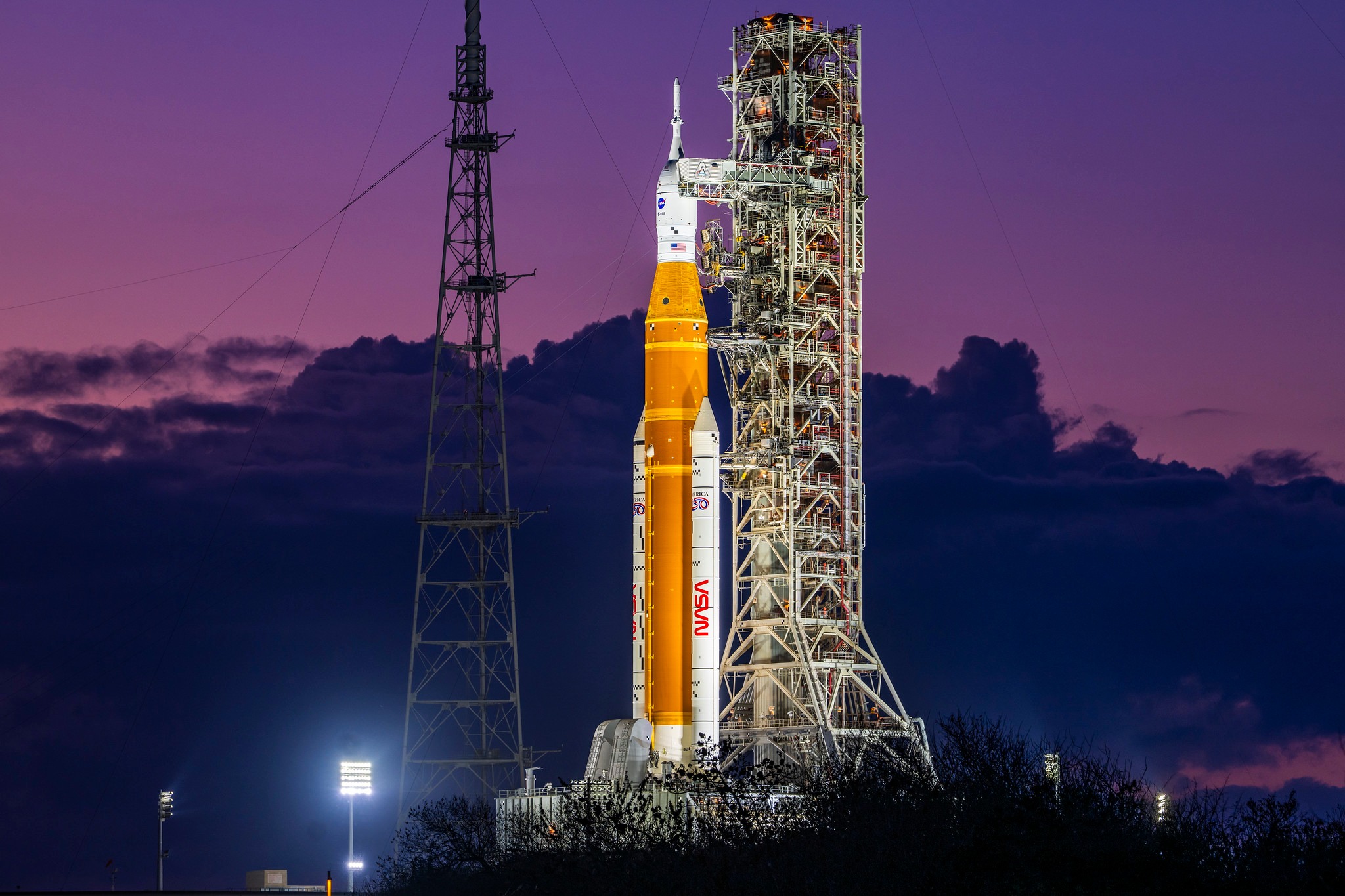 Illuminated Artemis II rocket on the launch pad
